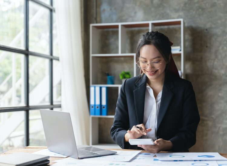 Asian woman accountant working with computer and calculator for business and financial expense