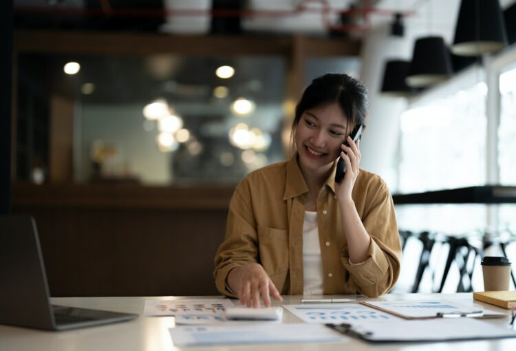 Business woman or accountant working audit while calling consultant her team. finance and accounting