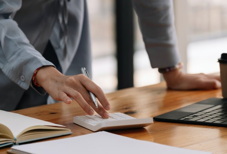 Close up of businesswoman accountant or banker making calculations.Business Financing Accounting
